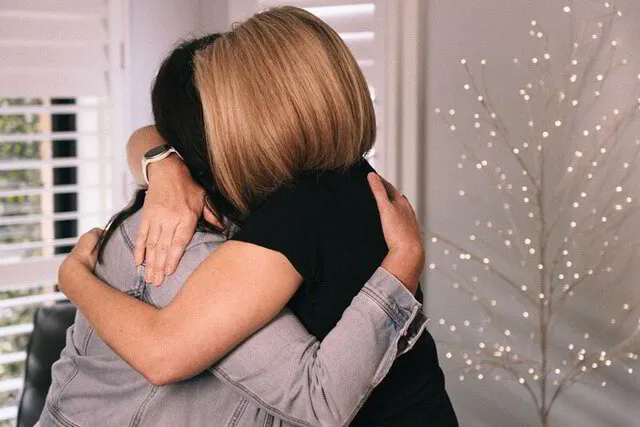Jo and her client hugging after a successful transformation