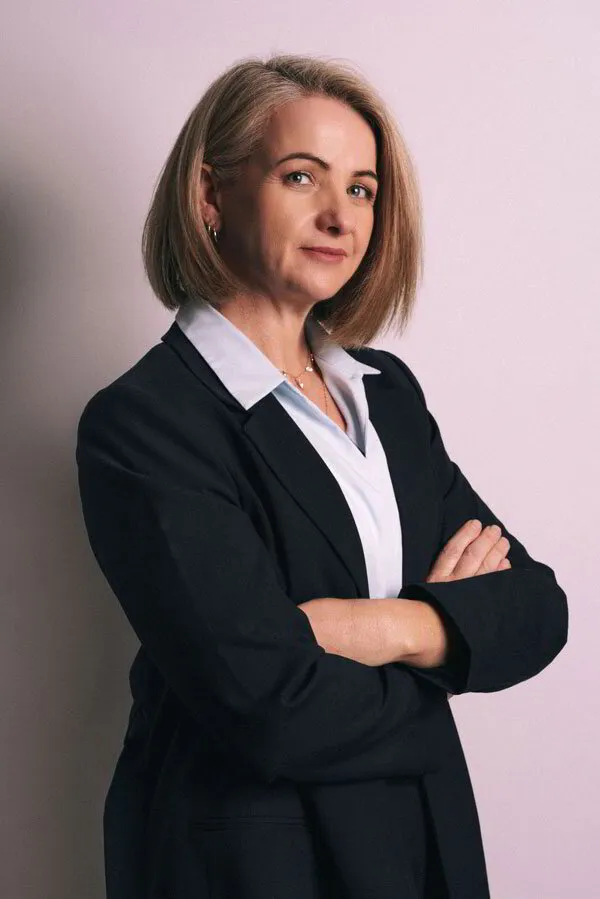 Headshot of Jo in a suit smiling at the camera