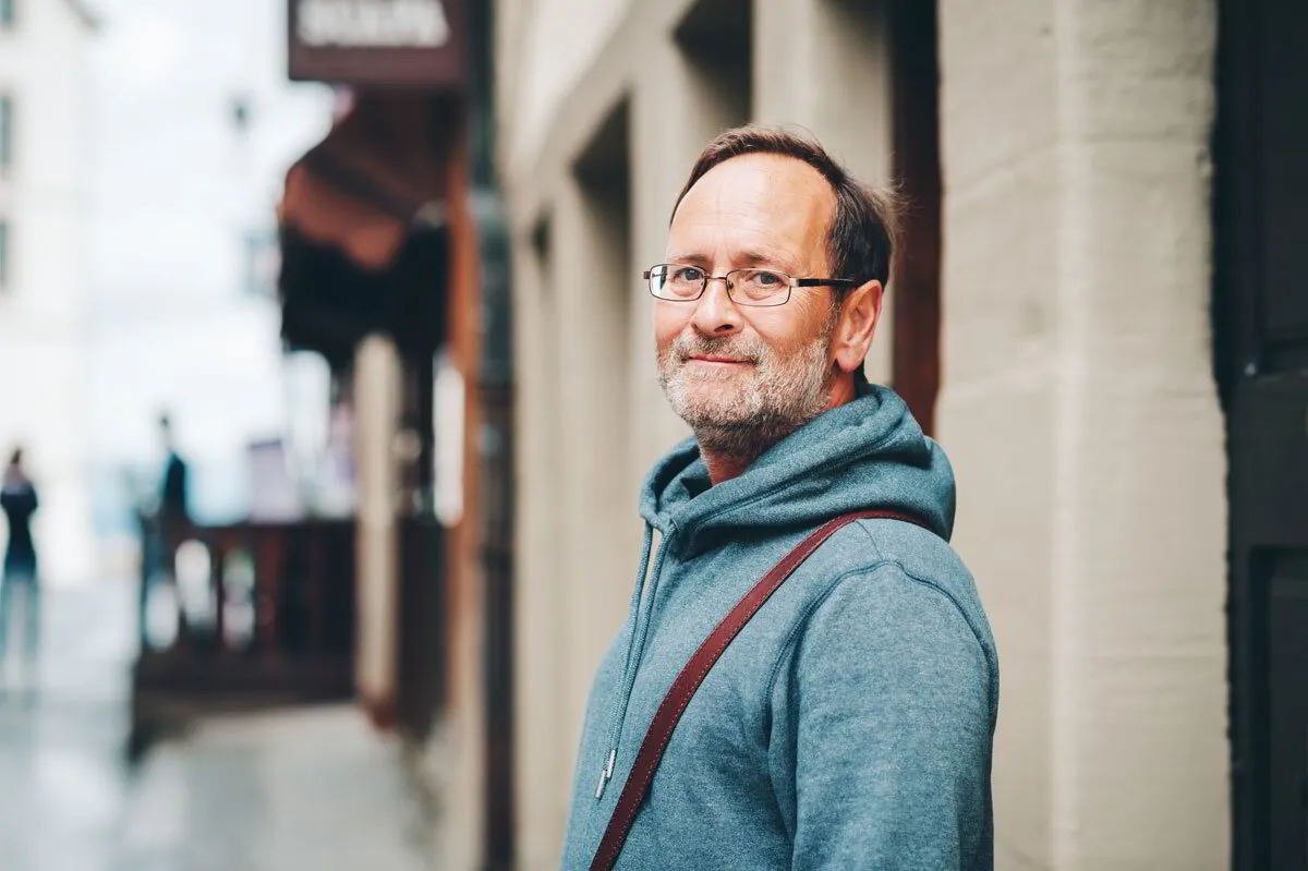 Man standing in the street smiling